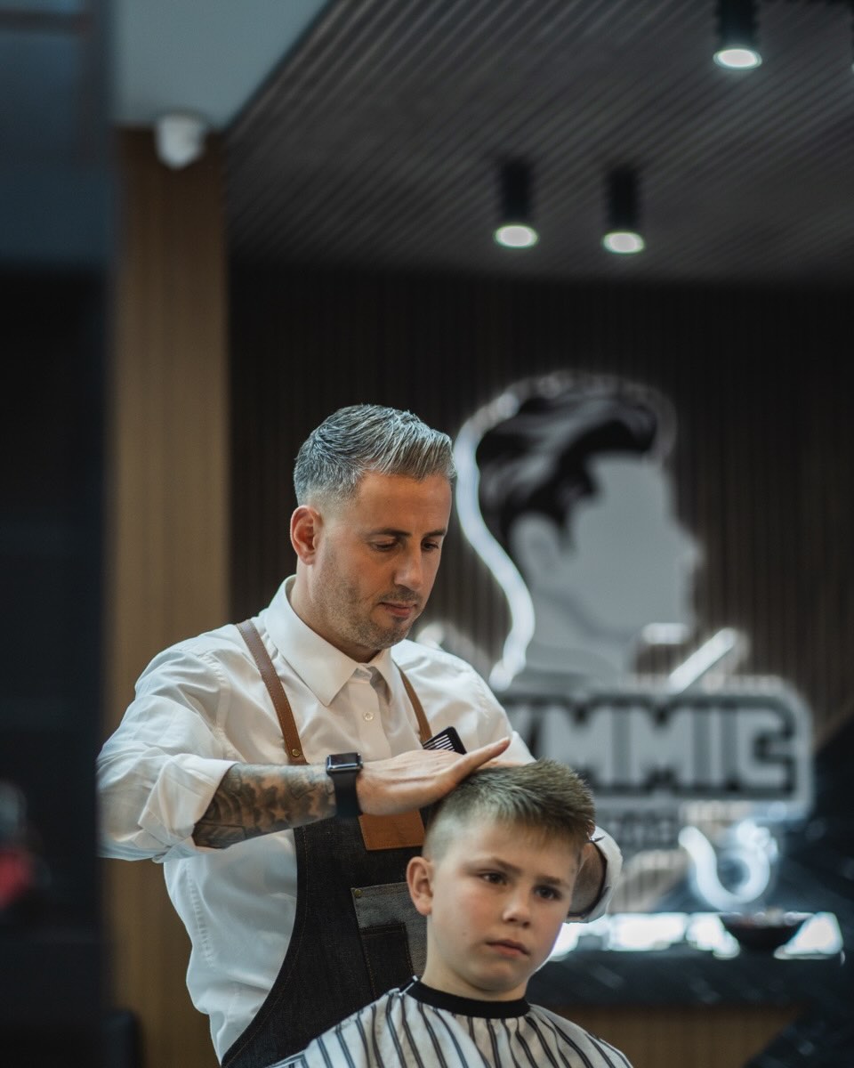 A master barber styling hair at Jimmy's Barbers